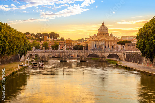 Daily view of San Pietro, Saint Peter basilica, with Sant'Angelo bridge and Tevere river in Rome, Italy photo