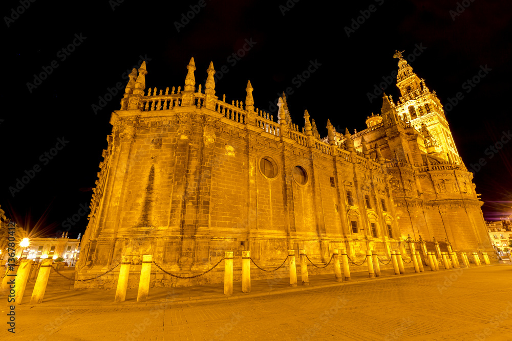The spectacular and illuminated Cathedral of Seville and Giralda by night, the world's largest Gothic Cathedral and the third religious building to size, Andalucia, Spain