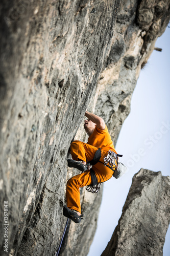 man climbs a rock