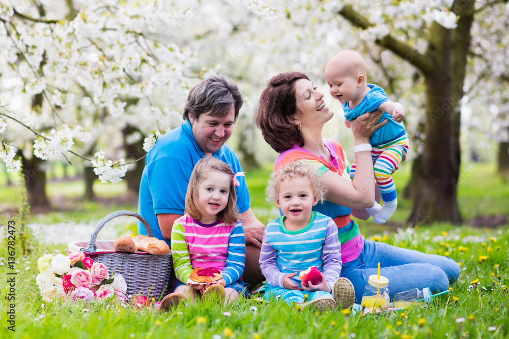 Family with children enjoying picnic in spring park Family with children enjoying picnic in spring park