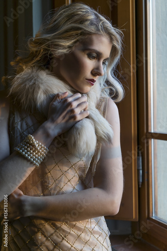 Blond girl posing with vintage clothes photo