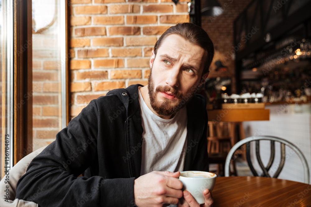 Serious Bearded man in cafe Serious Bearded man in cafe