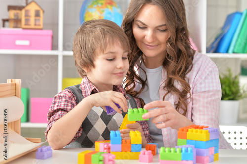 Woman and little boy playing blocks