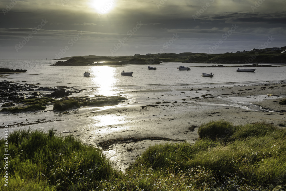 Coast sunset with boats in the night evening, County Donegal, Republic of Ireland