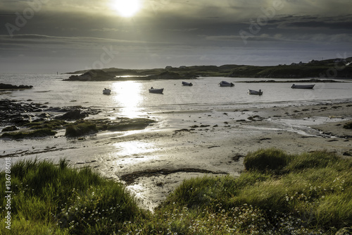 Coast sunset with boats in the night evening  County Donegal  Republic of Ireland