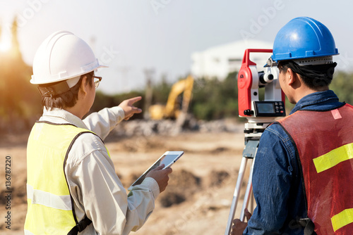 Civil Engineers At Construction Site and A land surveyor using an altometer photo