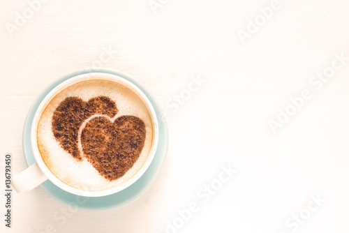 Coffee with decorated heart shaped cinnamon powder. St. Valentine's Day. Love. White background with copy space for text