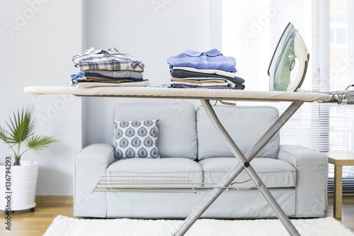 Fotografie, Obraz Ironing clothes on ironing board