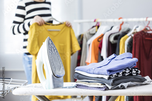 Tableau sur toile Ironing clothes on ironing board