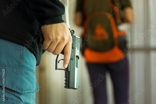 Hand of Thief with gun follow Woman Victim to Steal the Bag or M