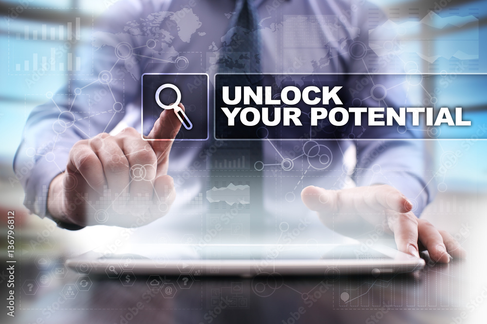 Fototapeta premium Businessman using tablet pc and selecting unlock your potential.