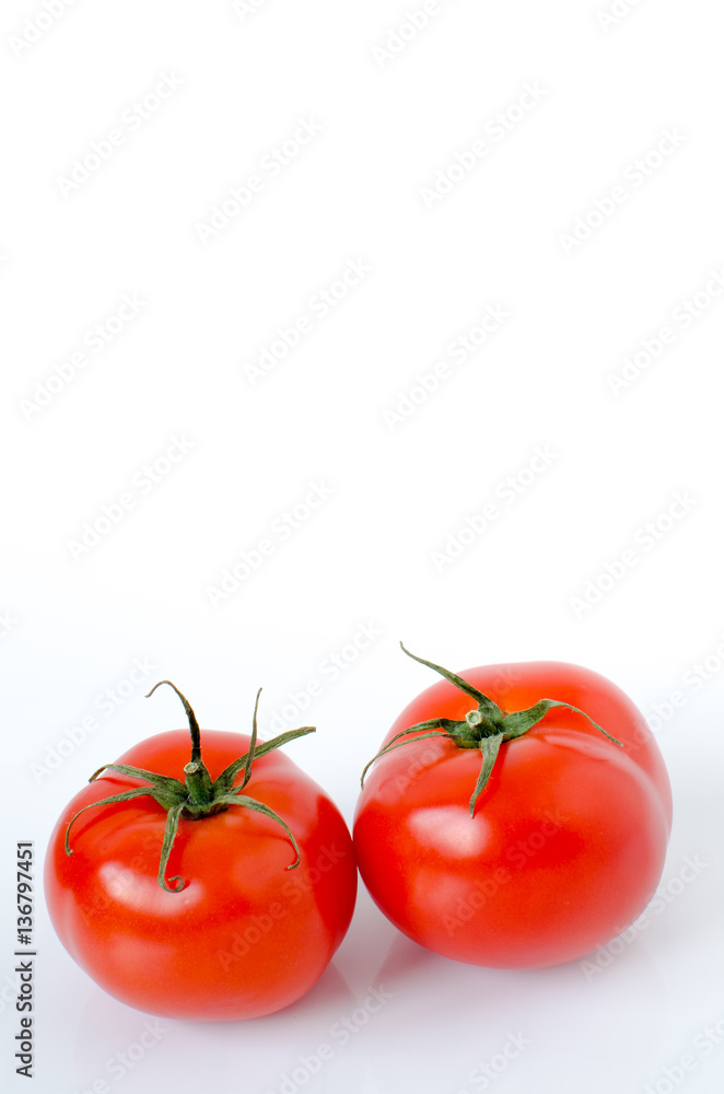 Two tomatoes on a white background Two tomatoes on a white background