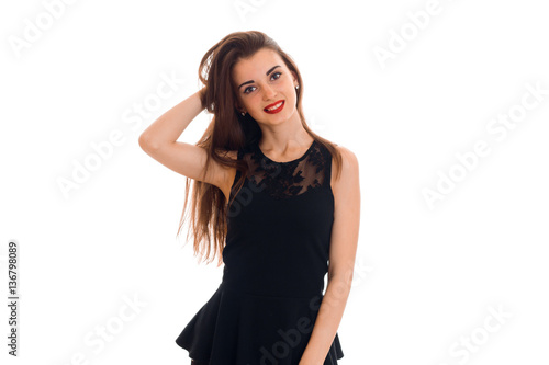 sexy young woman with red lips in black dress posing and smiling on camera isolated on white background