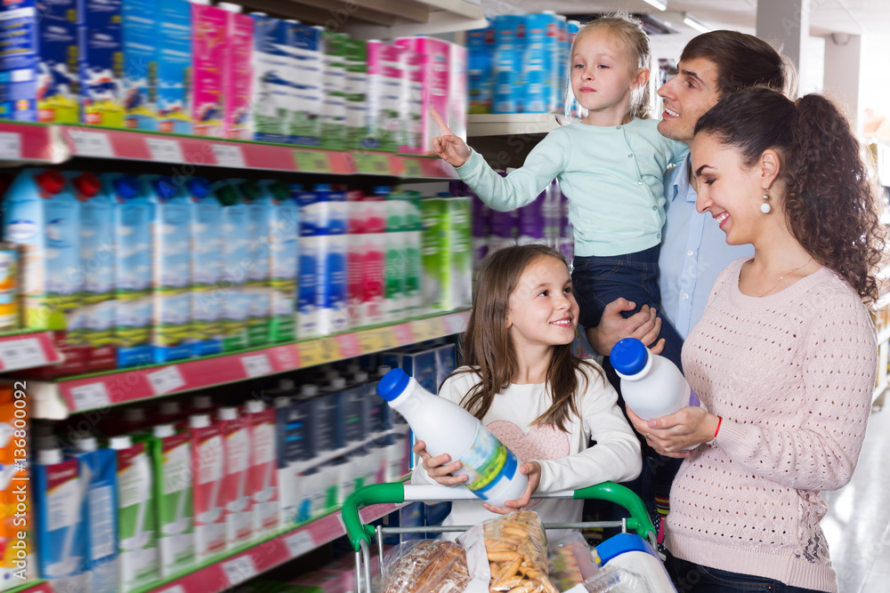 Customers with children selecting dairy products