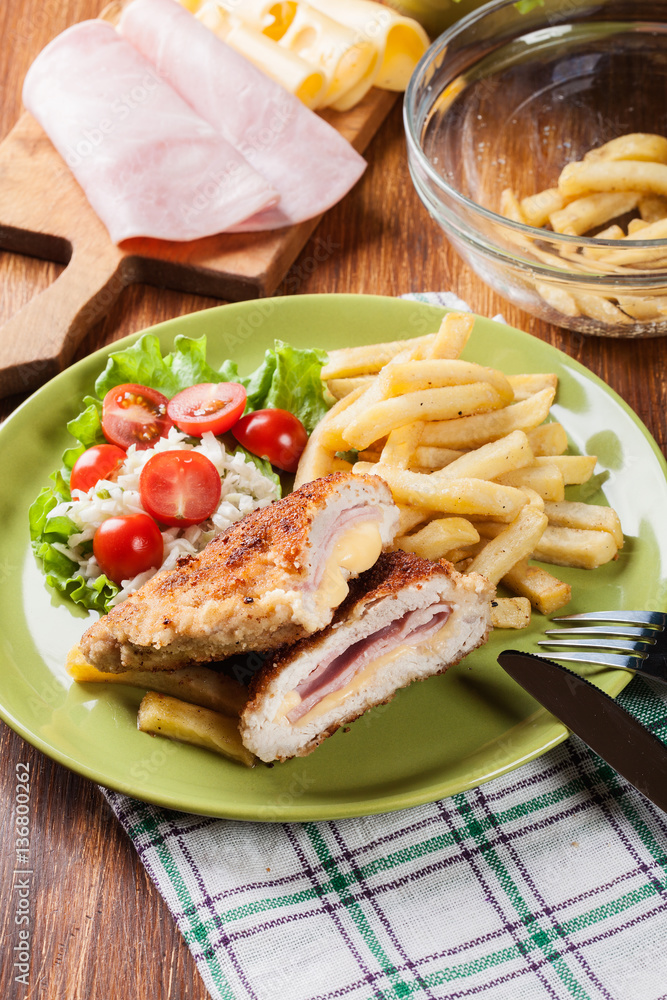 Cutlet Cordon Bleu with pork loin served with French fries and s Cutlet Cordon Bleu with pork loin served with French fries and s