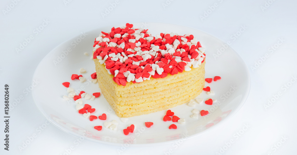 Pile of pancakes in the shape of a heart on plate with little su Pile of pancakes in the shape of a heart on plate with little su