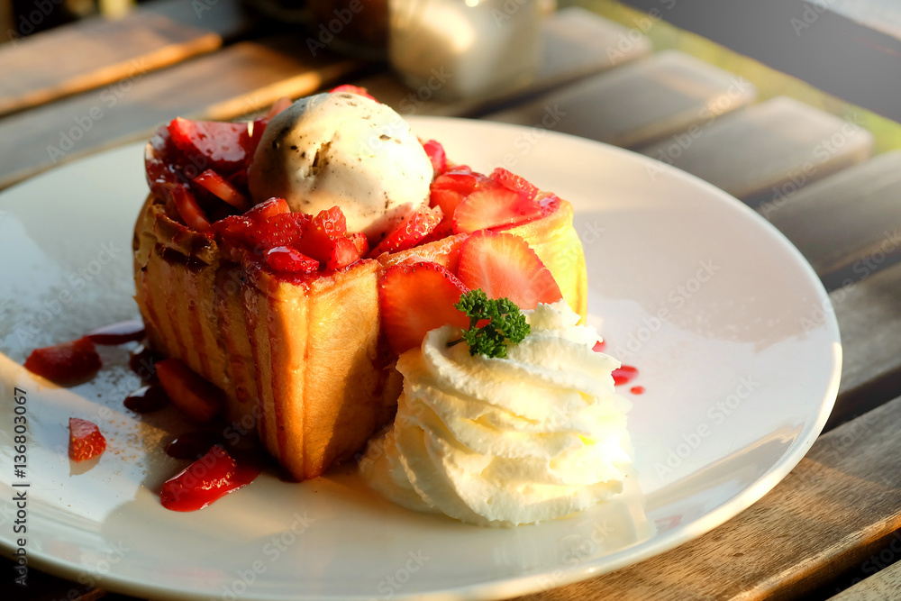 Dessert honey toast with ice cream and strawberry for romantic sweet time in valentine's day 