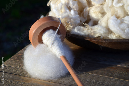 Drop spindle wrapped with handmade yarn made from the wool of a Gulf Coast Native sheep. photo