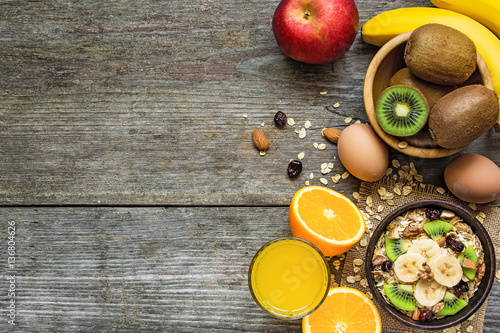 healthy breakfast with bowl of homemade oatmeal, fruits, egg and juice