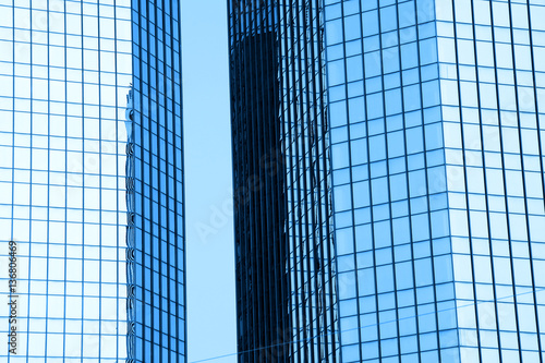 Two tall glass buildings in monochrome