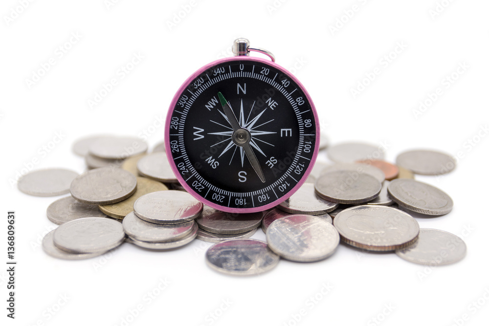 compass and coins on white background