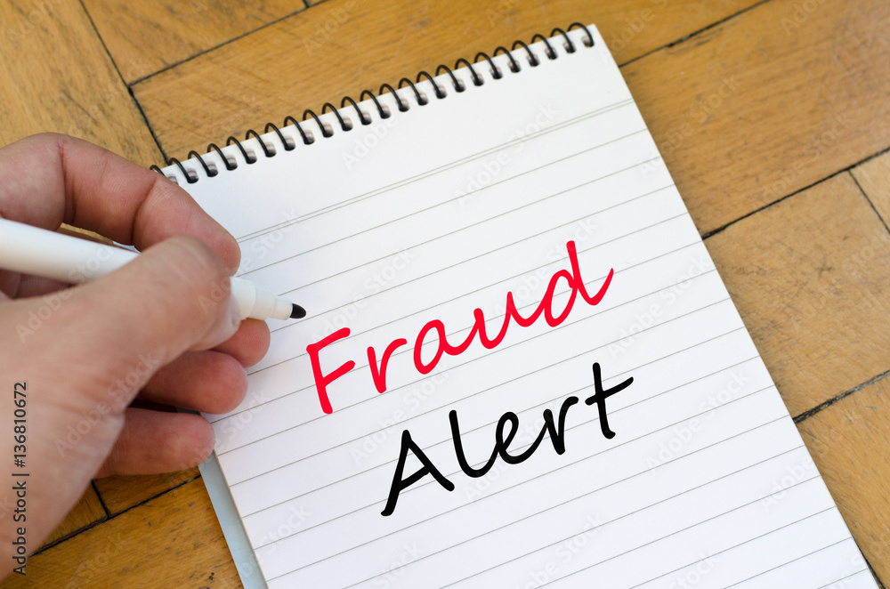 Fraud alert concept on notebook Fraud alert concept on notebook