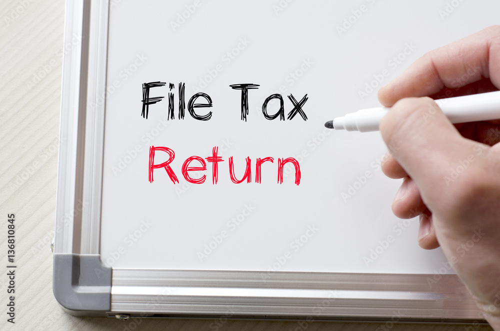 File tax return written on whiteboard File tax return written on whiteboard