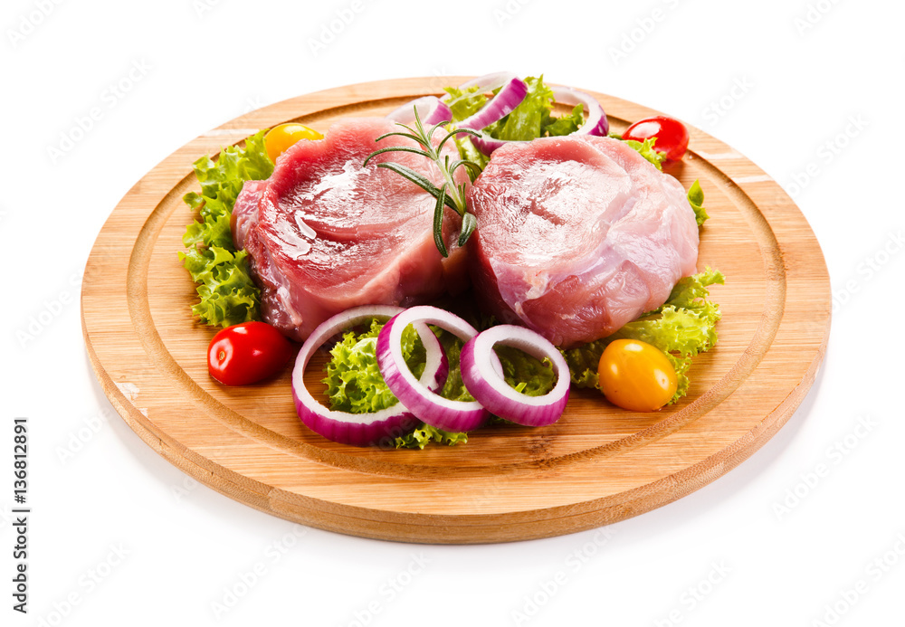 Fototapeta premium Raw meat on cutting board and vegetables 