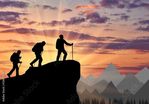 Tablou pe pânză Silhouette climbers ascending to top of mountain