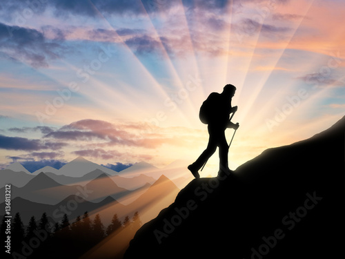Fototapeta Naklejka Na Ścianę i Meble -  Silhouette climber ascending to the top of the mountain