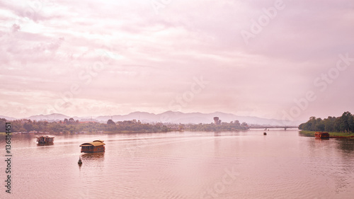 Hue, Vietnam - November 22, 2014: boats on the river lonely run to turn ripples, the mountains and the clouds away is to make real peace scenery of the countryside in Hue, Vietnam