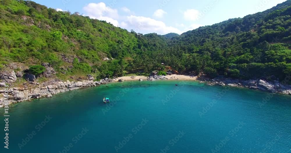 the hidden paradise beach look like horseshoe.The beach is not too long on the right side full of large stone.the sea is blue colour. 
