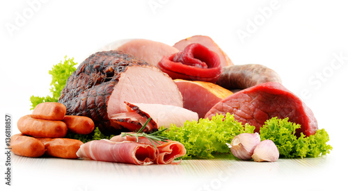 Meat products including ham and sausages isolated on white photo