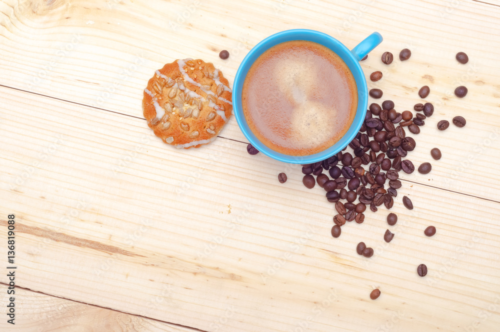 Cup of coffee, cookie with sunflower seeds and coffee beans, top Cup of coffee, cookie with sunflower seeds and coffee beans, top