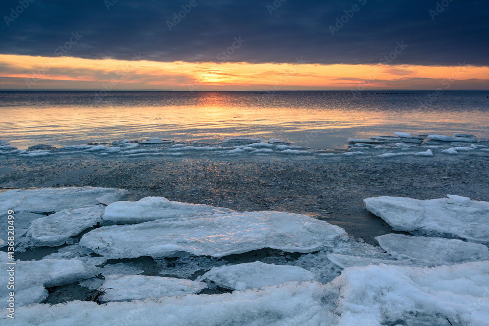 Sunset over frozen Baltic Sea in winter. Poland.