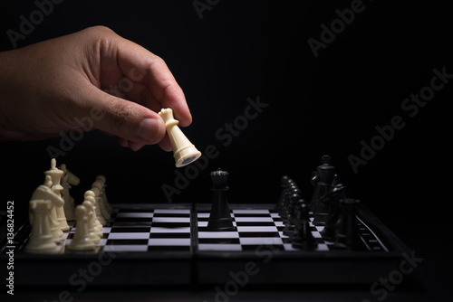 One chess pieces staying against black chess pieces