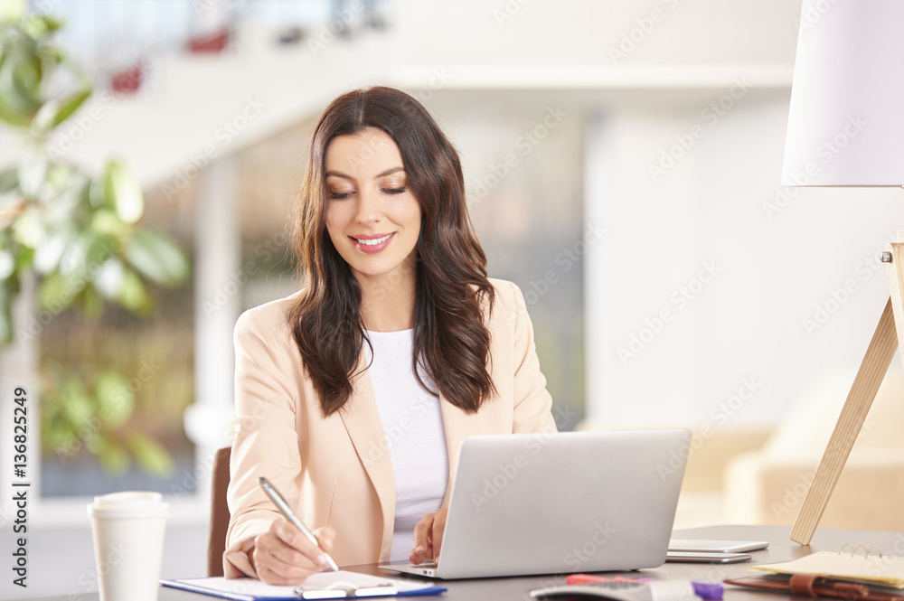 Professional businesswoman working on laptop in the office Professional businesswoman working on laptop in the office