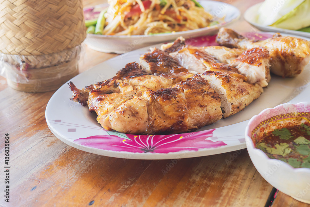 Thai style spicy meal, chicken grilled with spicy papaya salad and sticky rice box Thai style spicy meal, chicken grilled with spicy papaya salad and sticky rice box