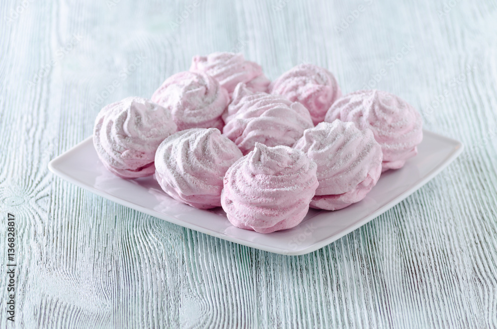 lovely pastel rose meringues, zephyrs, marshmallows on the wooden vintage table lovely pastel rose meringues, zephyrs, marshmallows on the wooden vintage table