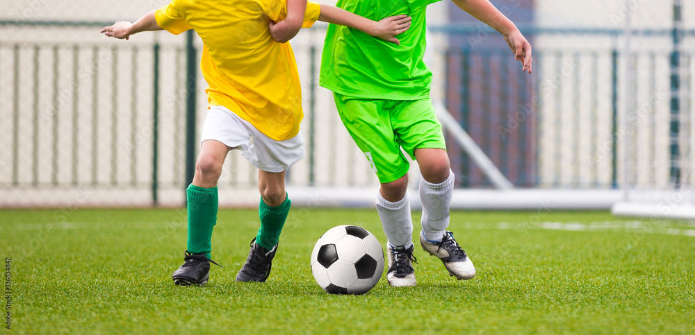 Obraz premium Running Children Football Soccer Players with Ball. Footballers Kicking Football Match on the Pitch. Young Teen Soccer Game. Youth Sport Background