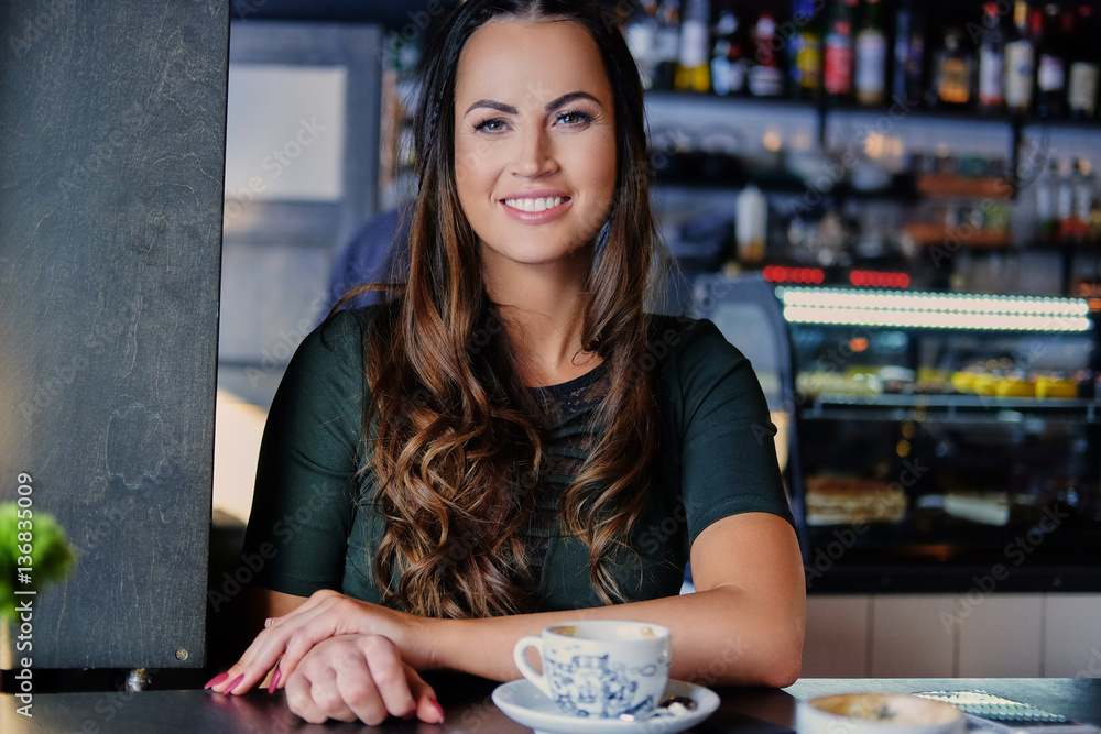 Fototapeta premium Brunette woman in a cafe.