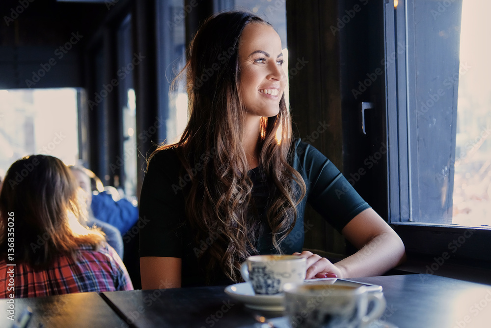 Brunette woman in a cafe. Brunette woman in a cafe.