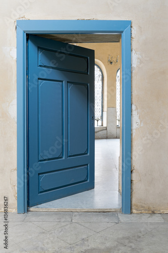 Blue wooden vintage door with yellow plaster wall © Khaled El-Adawi