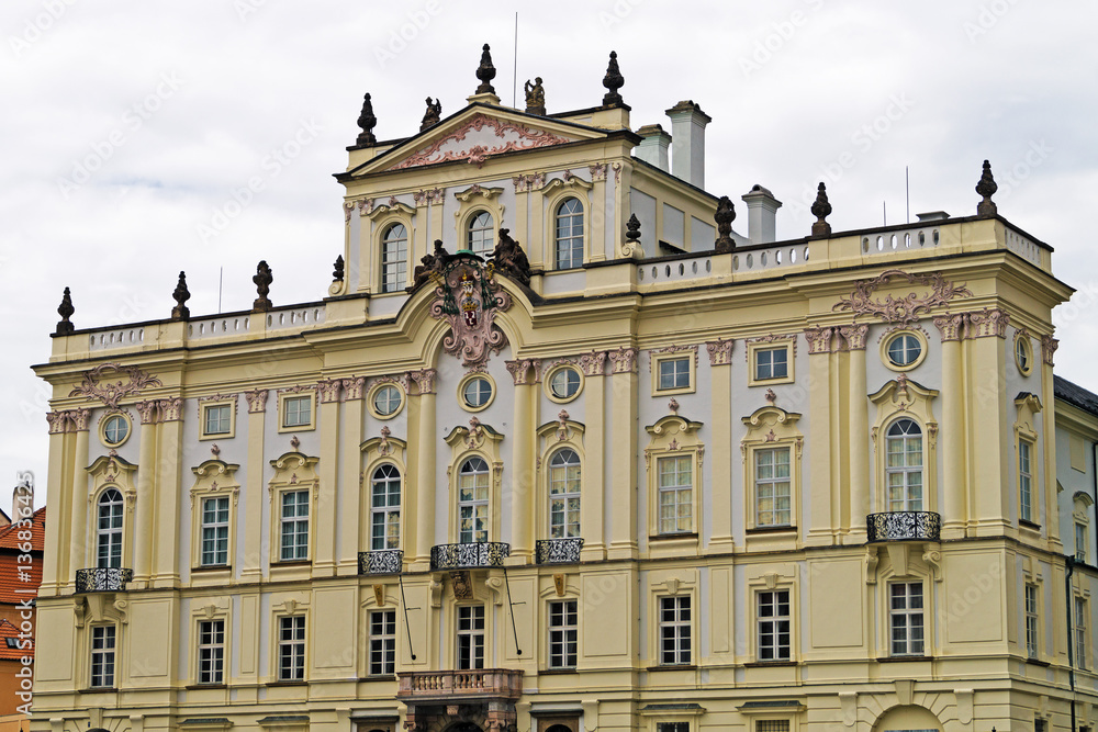 Classical light yellow municipal building in Prague.