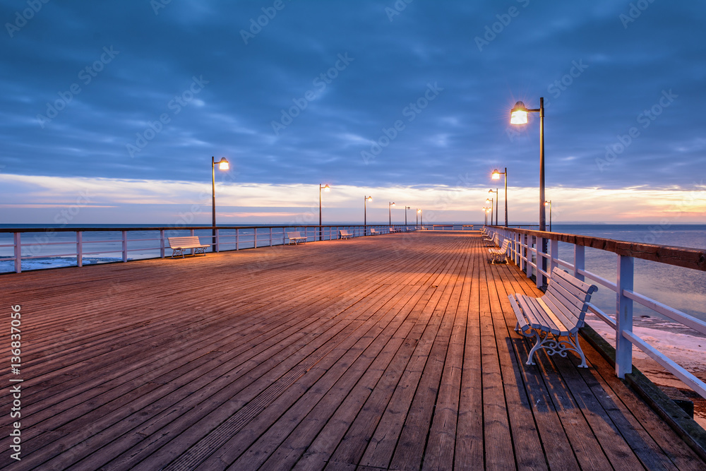 Cold evening at the pier in Jastrania in winter time. Poland. 