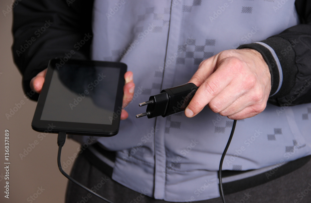 Man charging tablet Man charging tablet