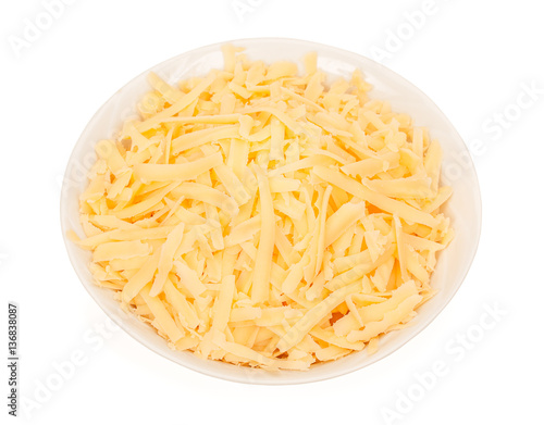 Bowl of grated cheese isolated on white background. close up