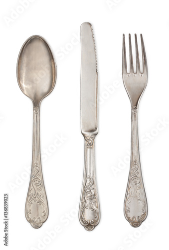 Antique silverware: spoon, knife and fork isolated on a white ba