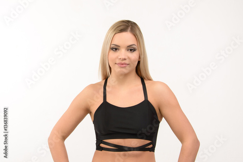 Beautiful sports blonde sexy girl on a white background