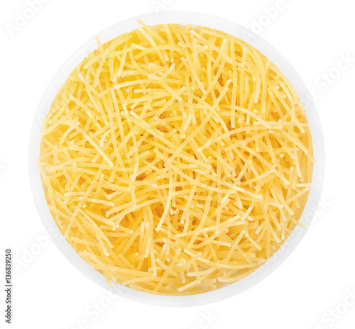 Pasta noodles in round plate isolated on a white close up top vi